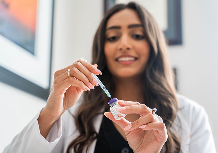 Surgical nurse at Advanced Plastic Surgery showing BOTOX injection